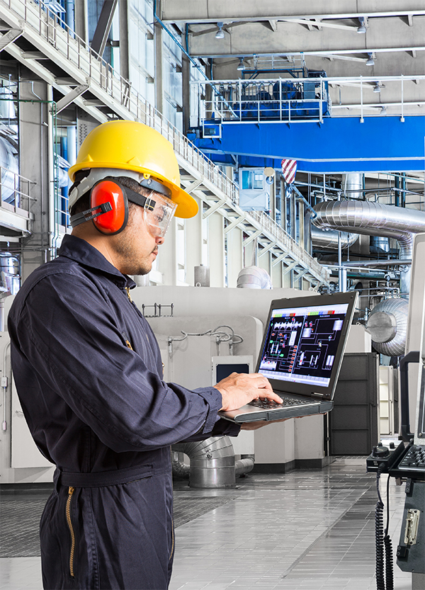 Engineer holding laptop and examining performance. 